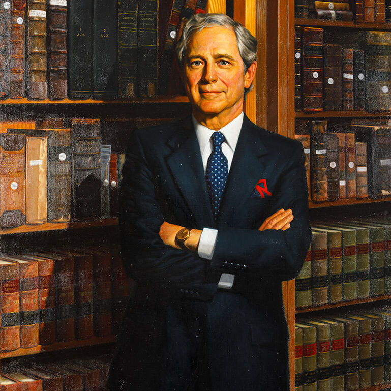 Portrait of Edward J. Bloustein standing in front of bookcase