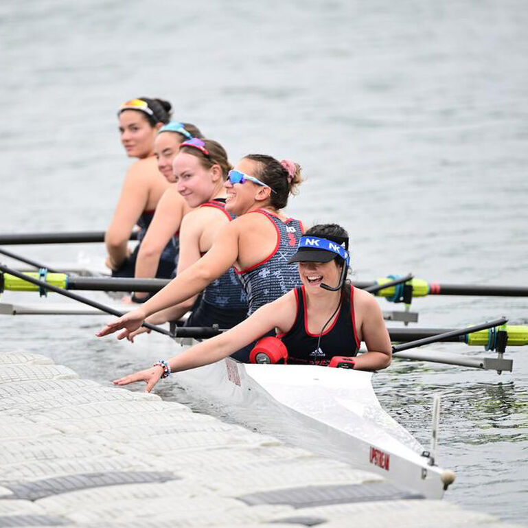 Rutgers Women's Rowing team in their boat on the water
