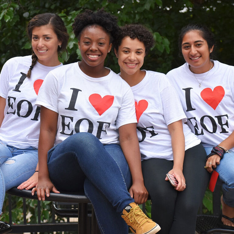 Four smiling students wearing I heart EOF t-shirts