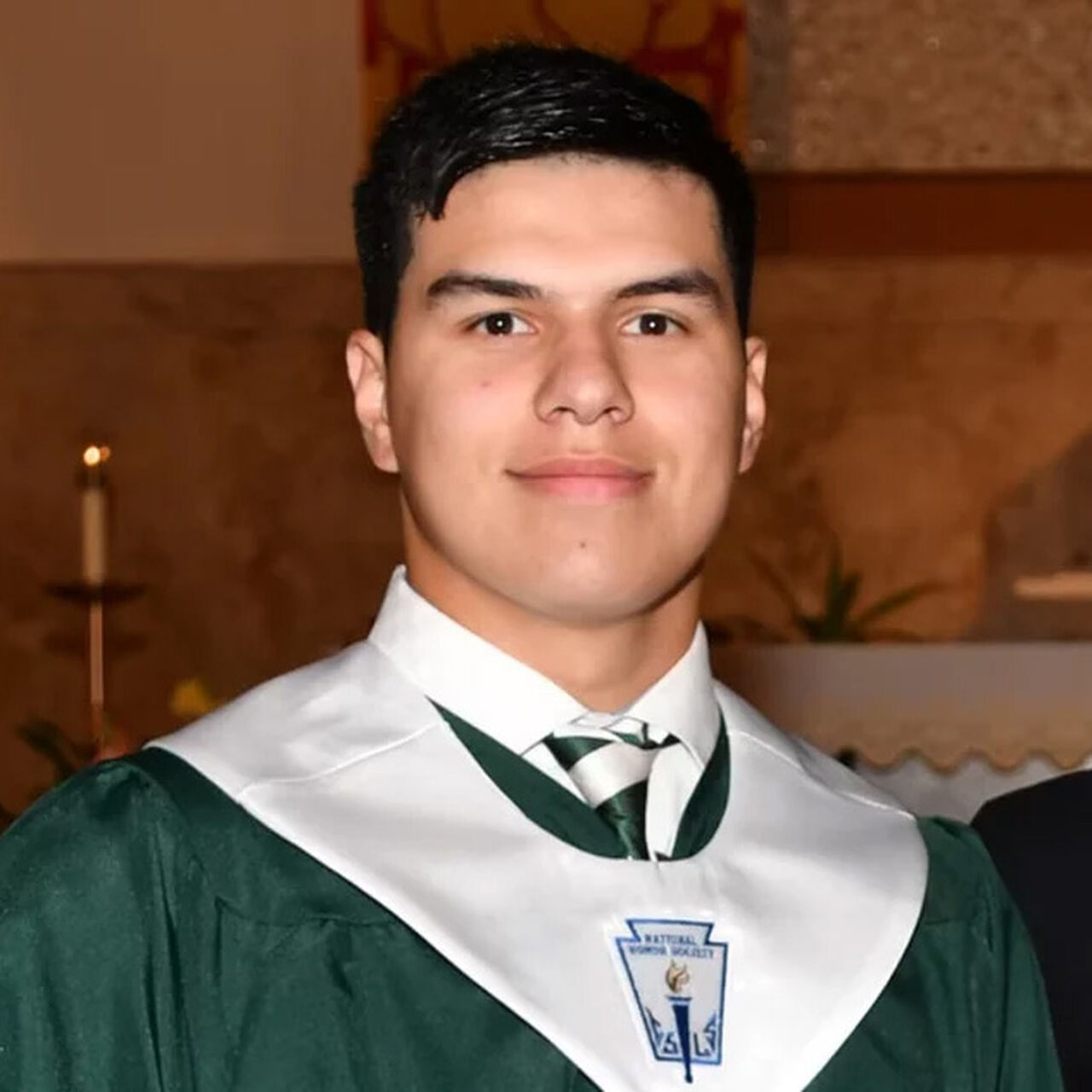 Close up picture of Daniel Anderl in high school graduation robes. image number 0