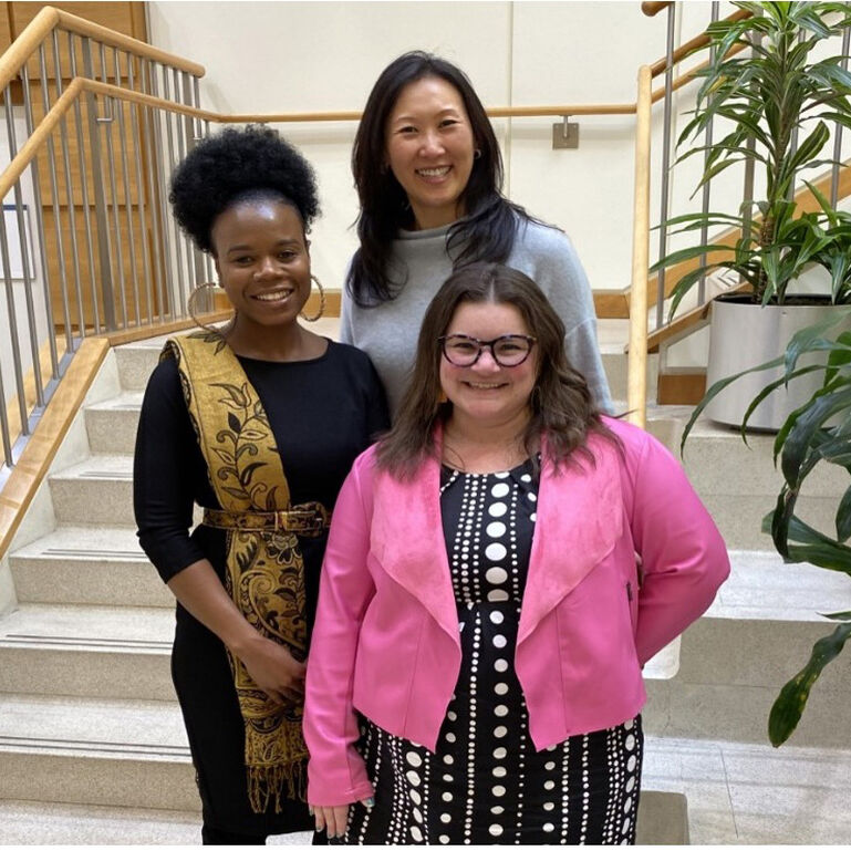 Three women on steps at Rutgers Cancer Institute