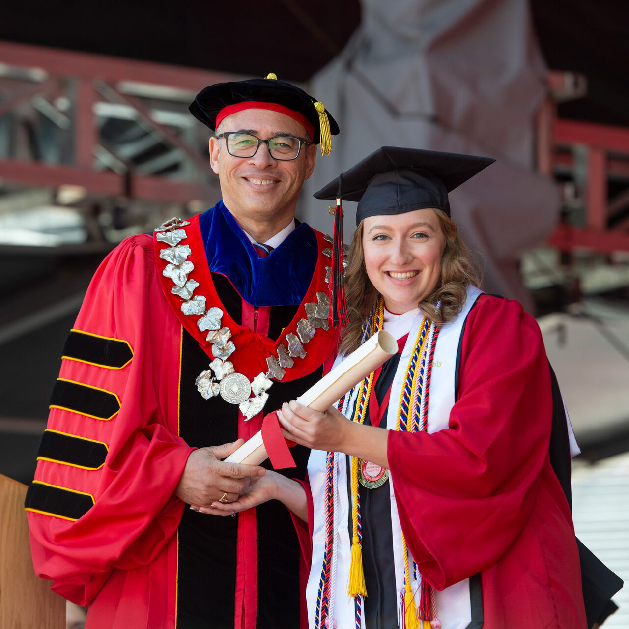 Rutgers President Jonathan Holloway and a student in graduation regalia at Commencement image number 0