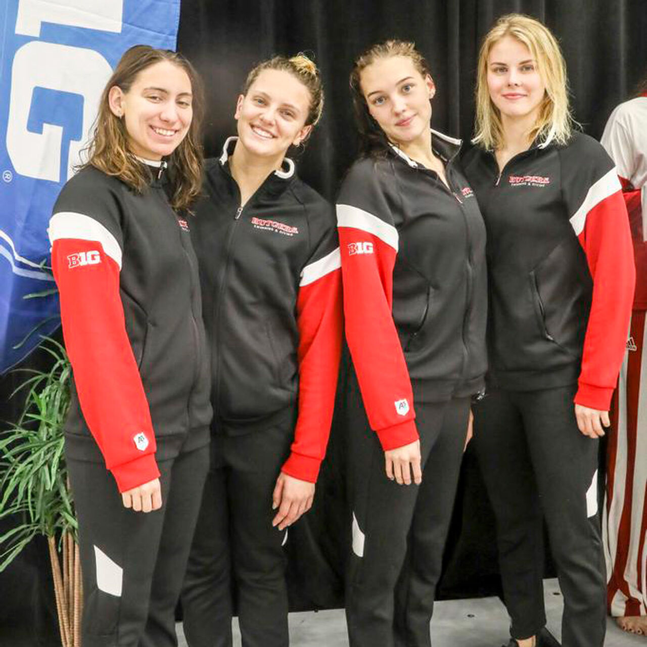 Four Rutgers Women's Swimming and Diving team members standing and smiling for the camera image number 0