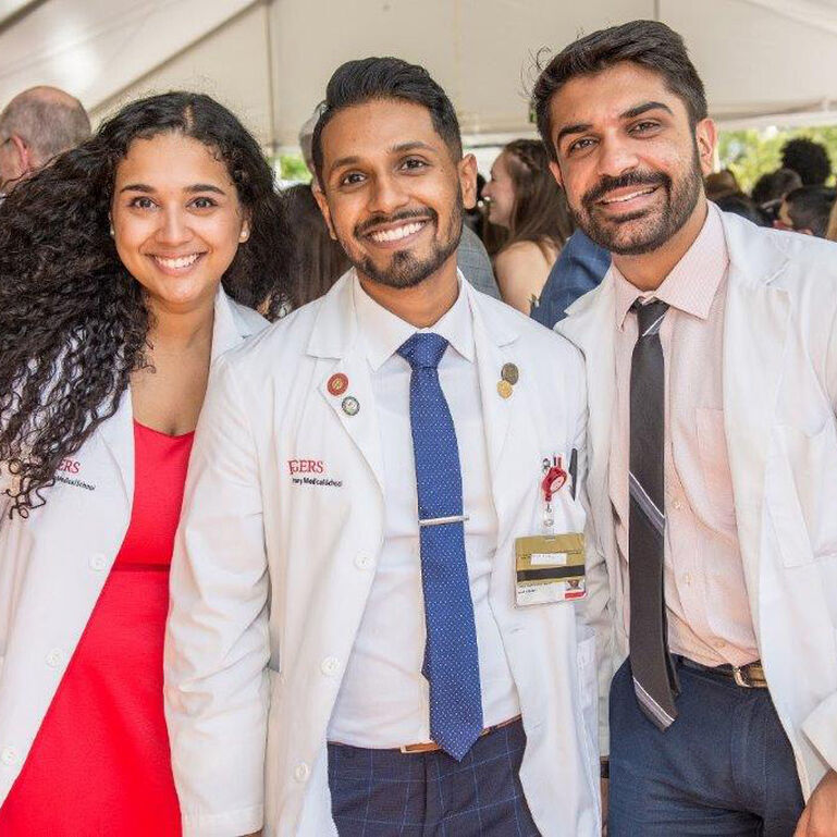 Three smiling medical students
