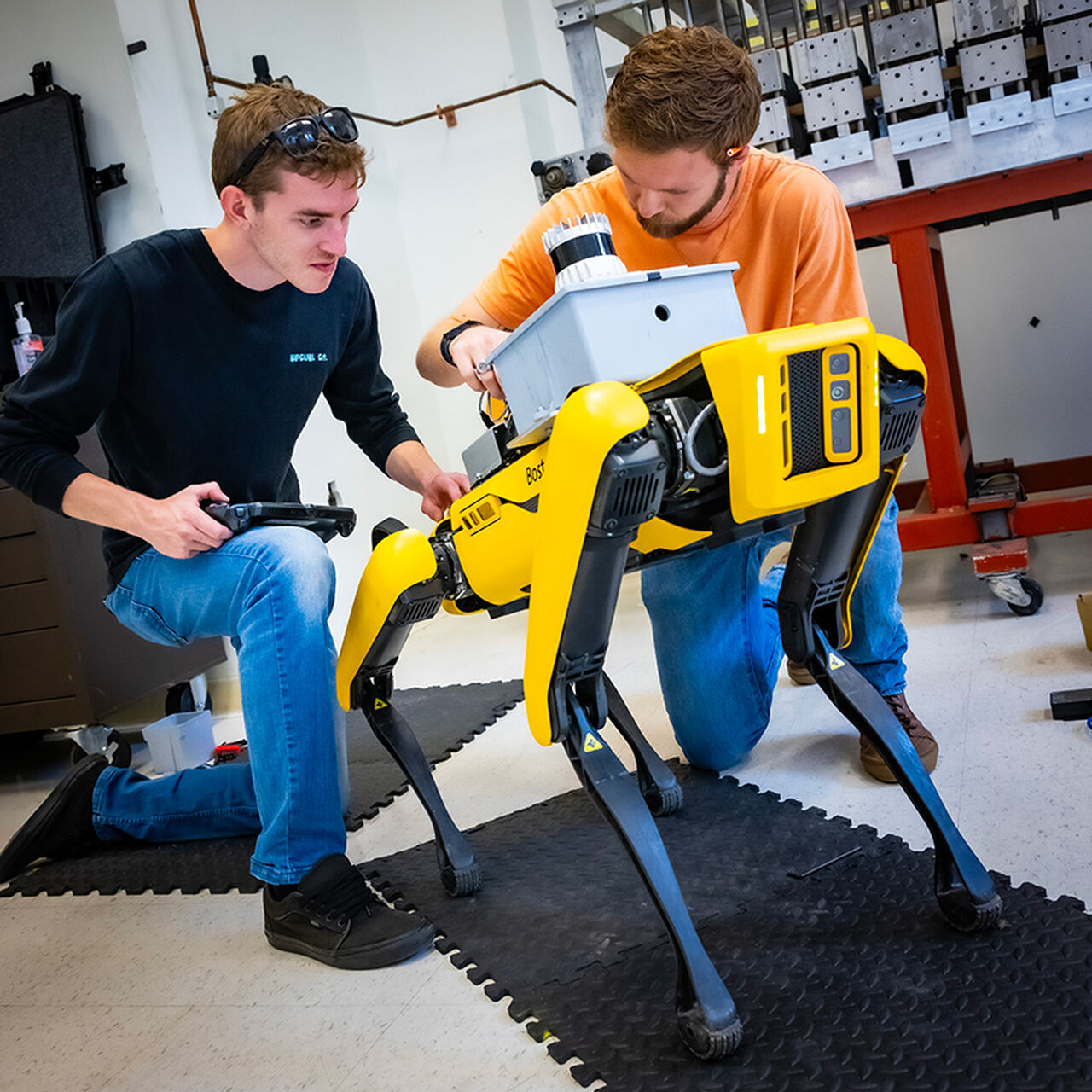 Two students working with robot dog image number 0