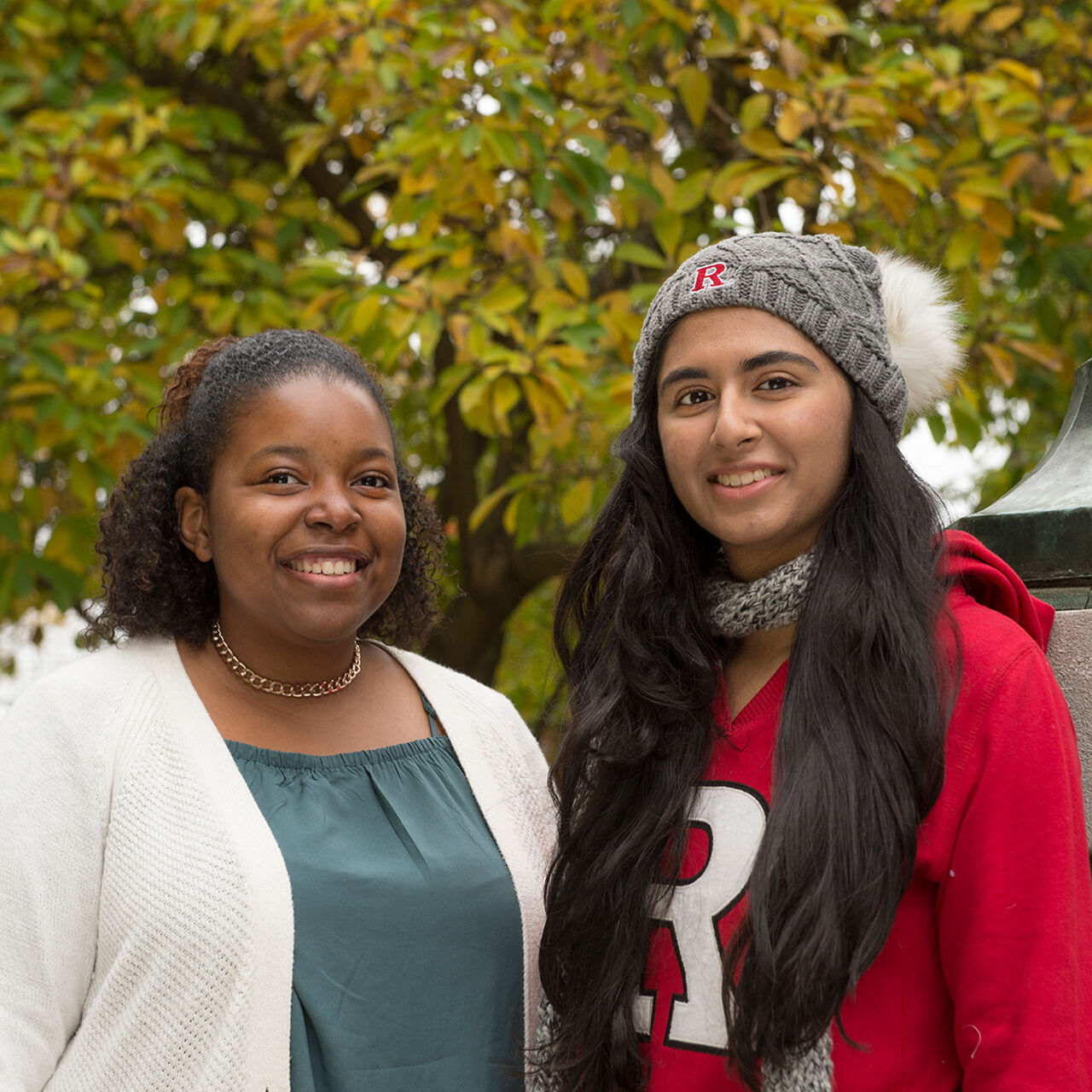 Two students smiling at the camera outside on the Rutgers New Brunswick campus image number 0