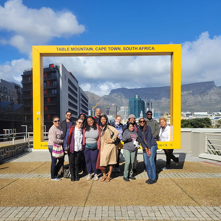 People standing outside in front of a sign for Table Mountain, Cape Town, South Africa