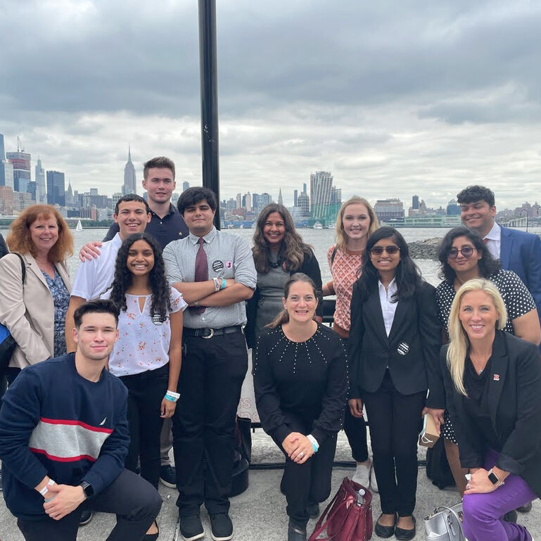 A group of students in front of a city skyline