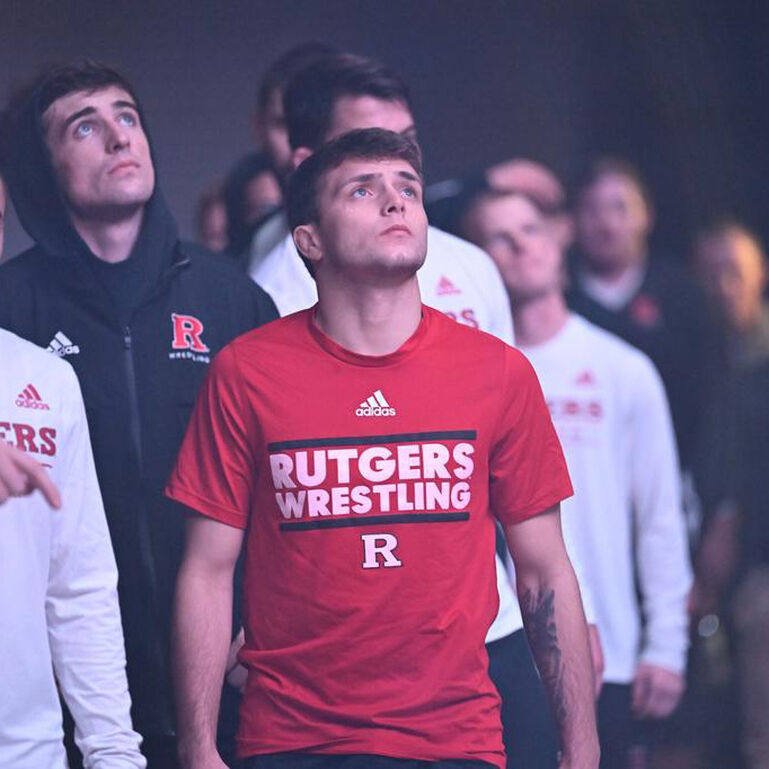 Rutgers Wrestling team members walking into a match