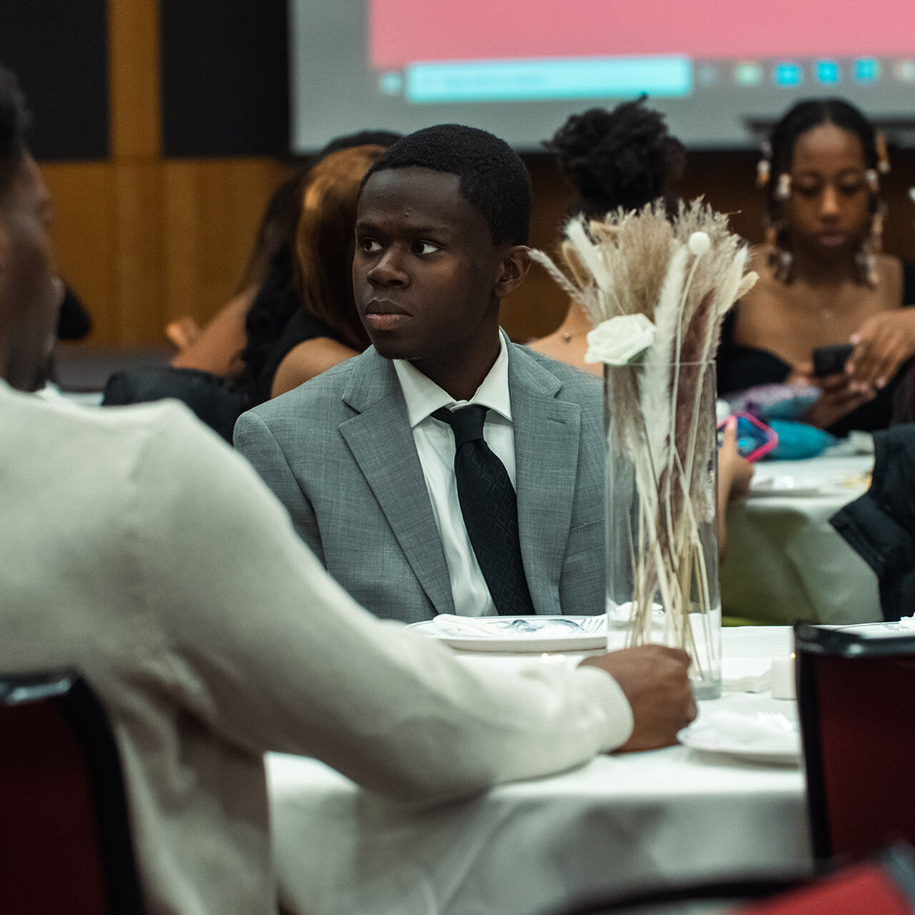 Student sitting at a dining table image number 0