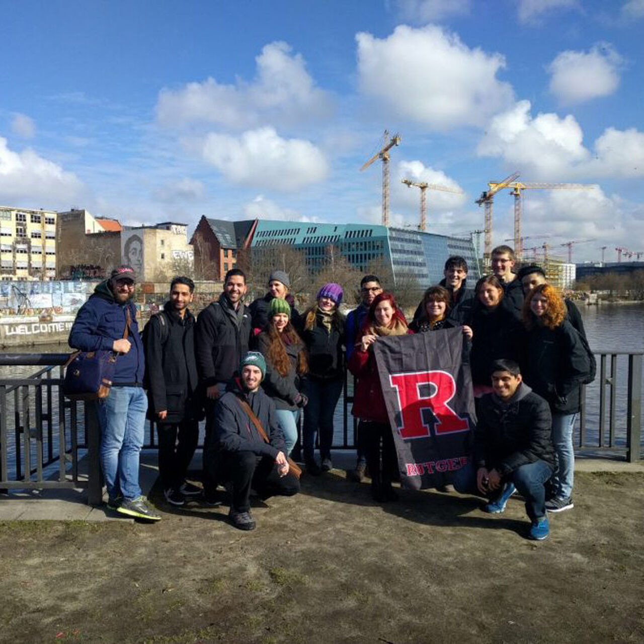 Students standing in a group outside holding a flag with a Rutgers R on it image number 0