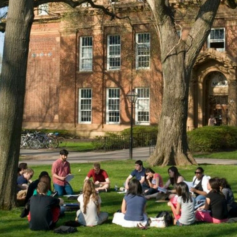 Two students walking into a building on the Rutgers-New Brunswick campus