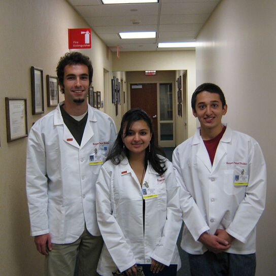 Three health profession students standing in hallway.  image number 0