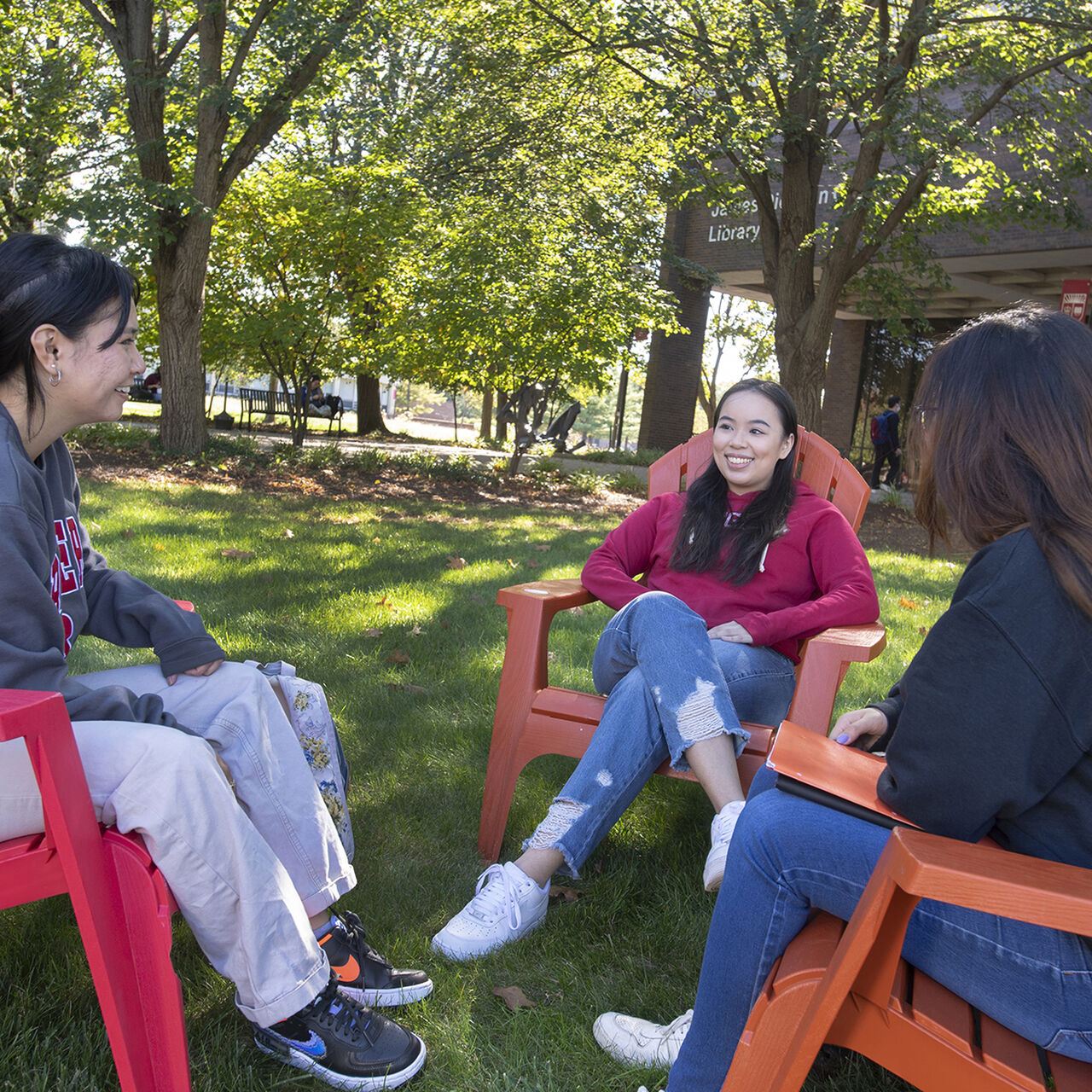 Students sitting in lawn chairs outside of the James Carr Library on the Livingston campus image number 0