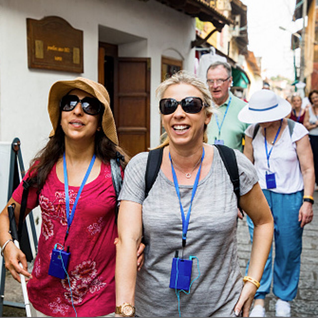 Two visually impaired women walking down the street image number 0