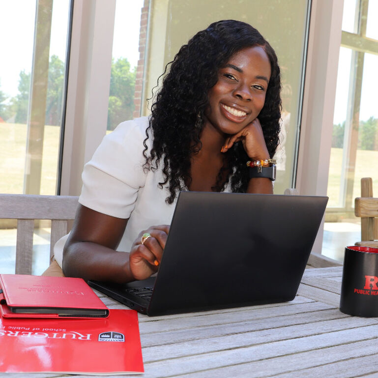 Student smiling with open laptop