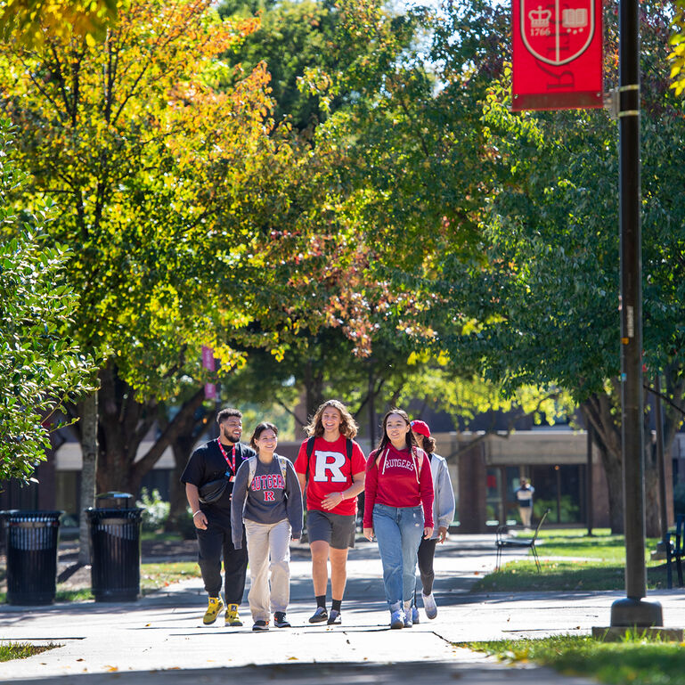 Students in Rutgers gear walking outside on the Rutgers New Brunswick campus