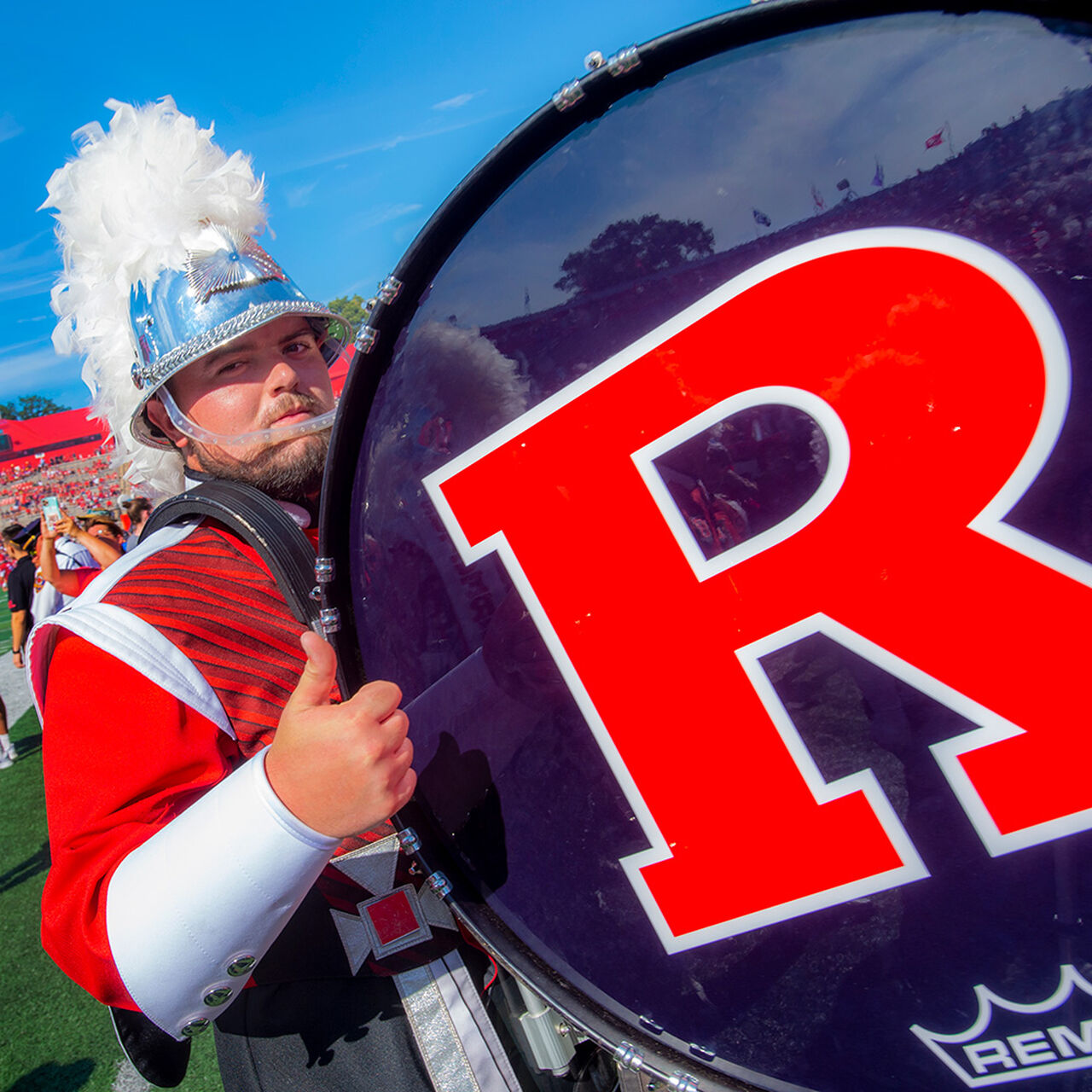 Bass drum player in the Scarlet Knight Marching Band giving a thumbs up to the camera image number 0