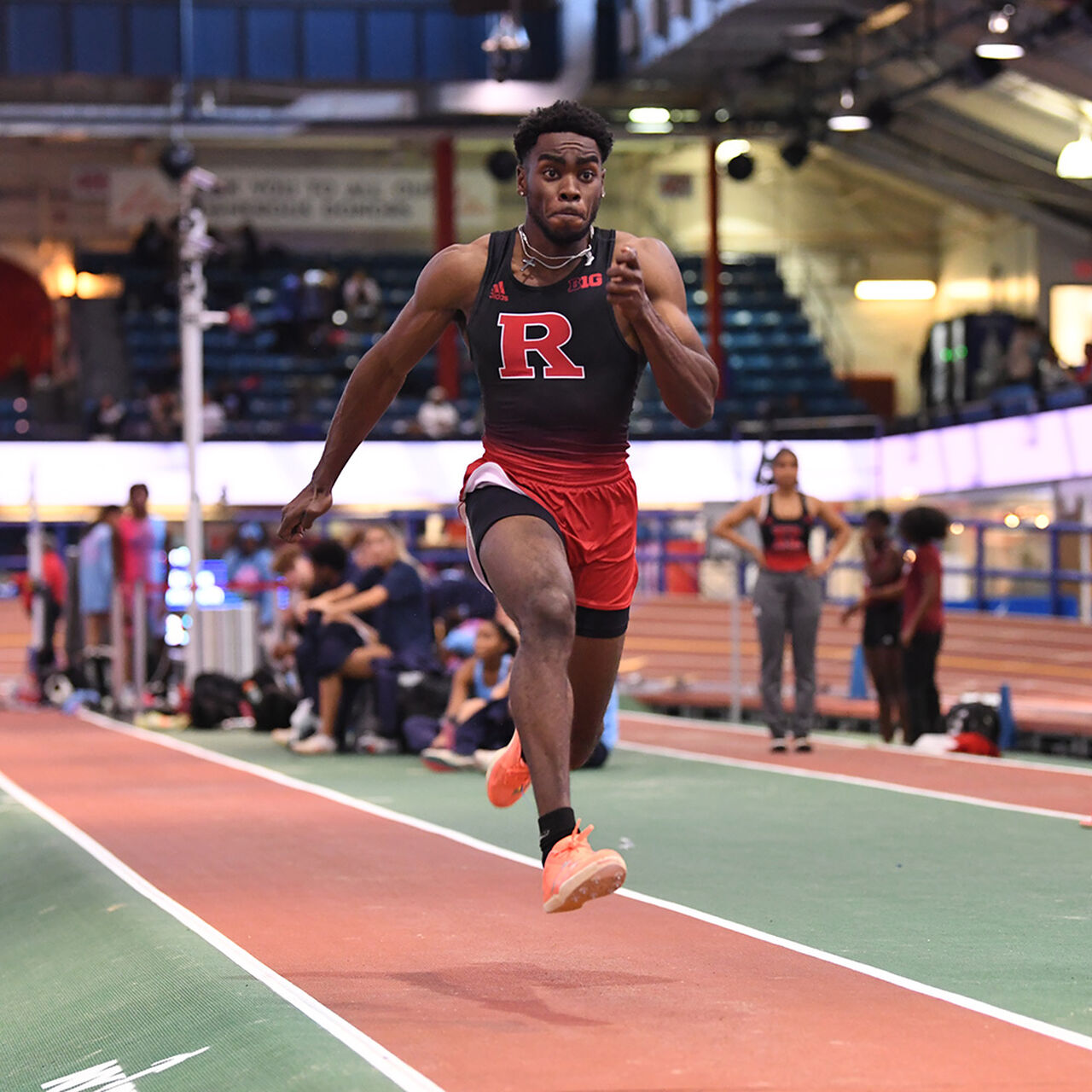 Scarlet Knight athlete running on an indoor track image number 0