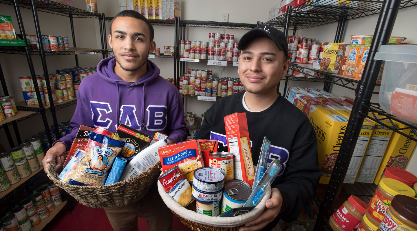 Volunteer restocking shelves at the Rutgers-Newark food pantry